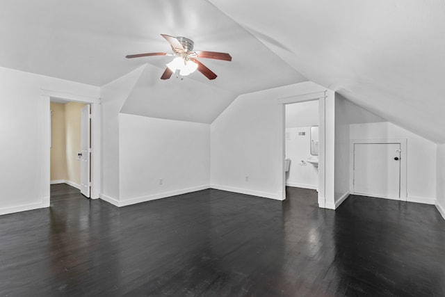 bonus room with lofted ceiling, dark hardwood / wood-style floors, and ceiling fan