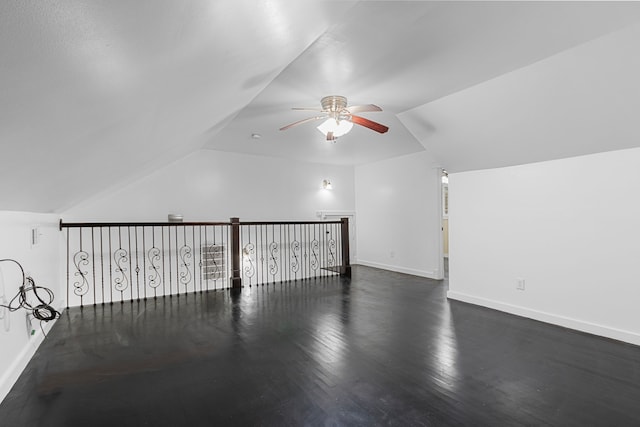 additional living space featuring vaulted ceiling, dark hardwood / wood-style floors, and ceiling fan