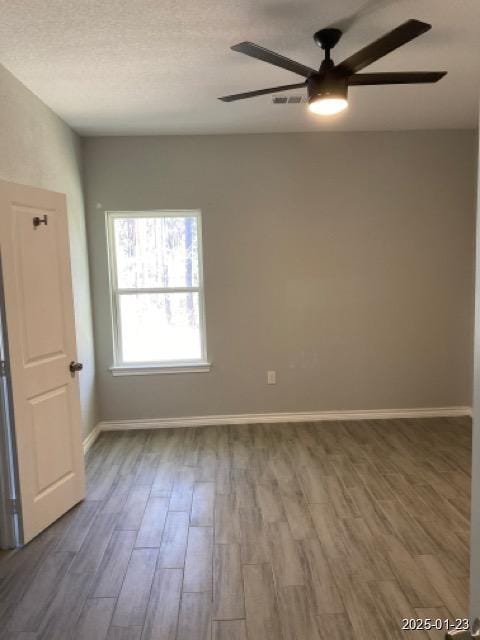 spare room featuring hardwood / wood-style floors, a textured ceiling, and ceiling fan