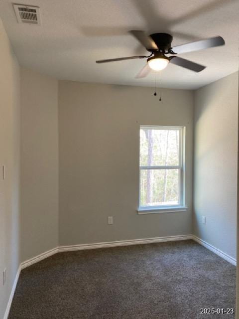 carpeted spare room featuring ceiling fan