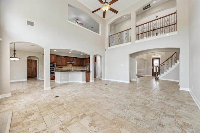 unfurnished living room featuring ceiling fan