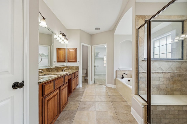 full bathroom featuring vanity, tile patterned floors, toilet, and separate shower and tub