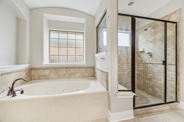 bathroom with tile patterned floors and independent shower and bath