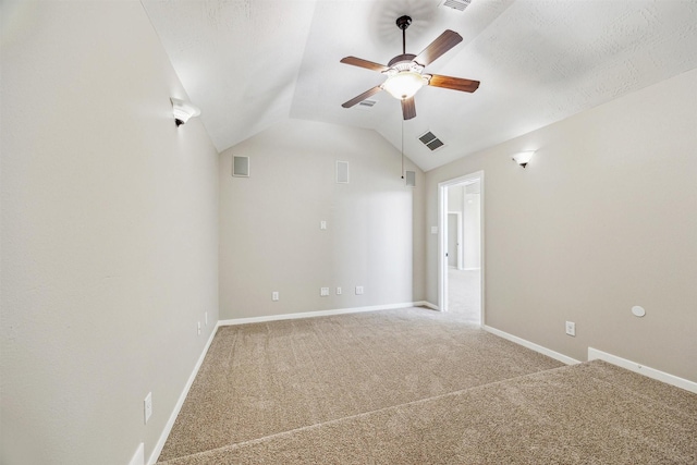 carpeted empty room featuring lofted ceiling, a textured ceiling, and ceiling fan