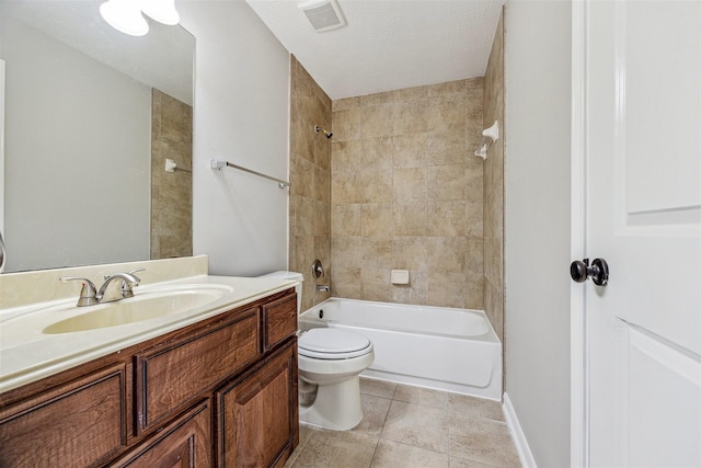 full bathroom featuring tiled shower / bath combo, vanity, tile patterned flooring, and toilet