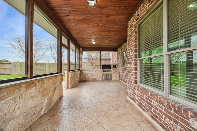 unfurnished sunroom with wood ceiling