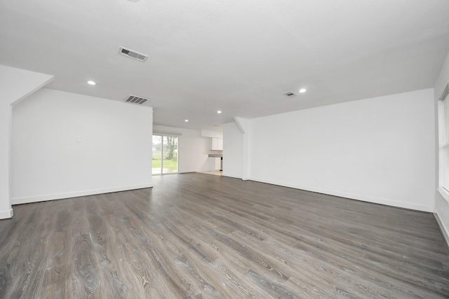 unfurnished living room with dark wood-type flooring