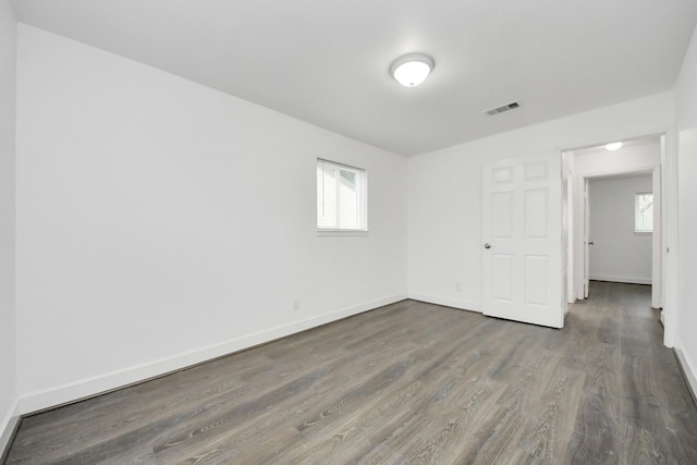 empty room with dark hardwood / wood-style floors