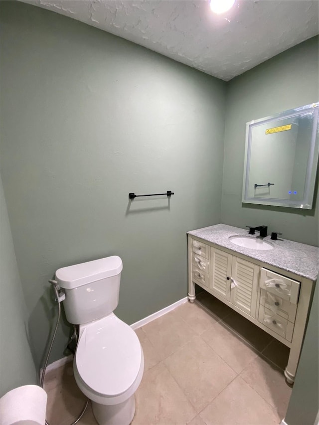 bathroom with tile patterned floors, toilet, and vanity