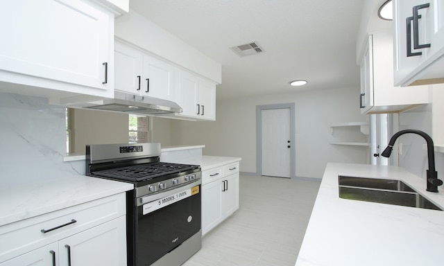 kitchen featuring white cabinetry, sink, and stainless steel range with gas stovetop