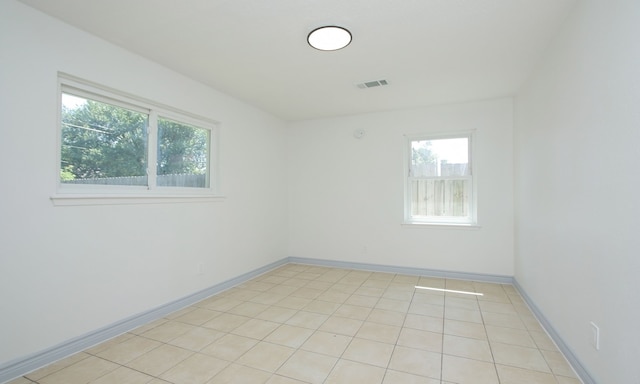 empty room with light tile patterned floors