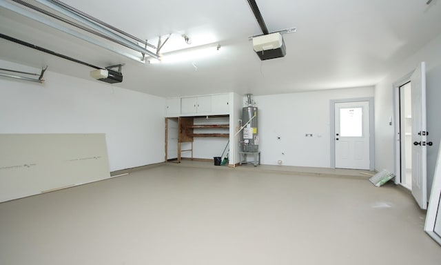 garage with a garage door opener and water heater