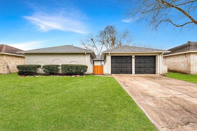 ranch-style home featuring a garage and a front yard