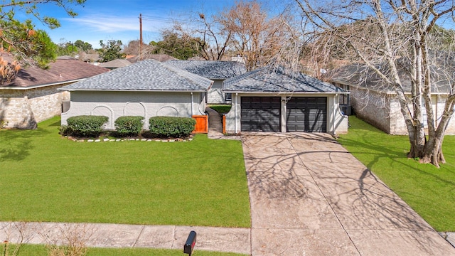 ranch-style home featuring a garage and a front lawn