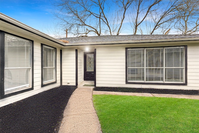 doorway to property with a yard