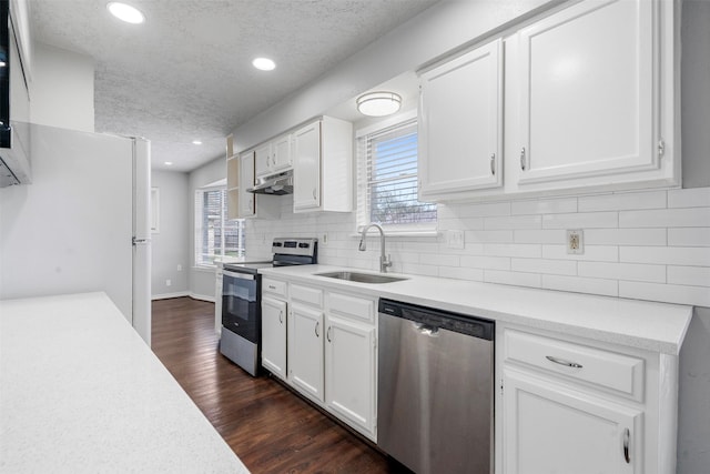 kitchen featuring stainless steel appliances, sink, and white cabinets