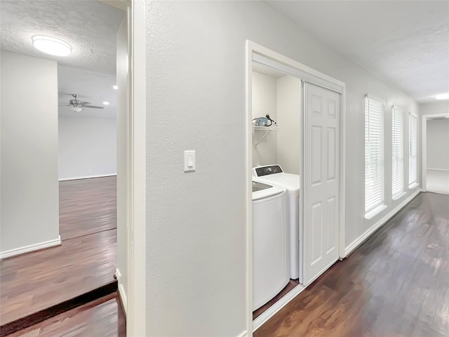 washroom featuring ceiling fan, separate washer and dryer, dark hardwood / wood-style floors, and a textured ceiling