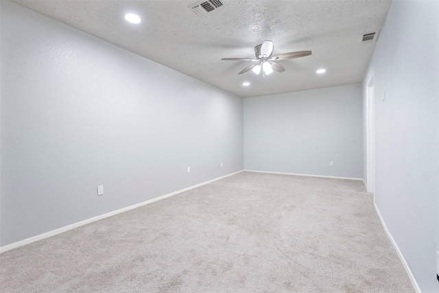 carpeted spare room featuring a textured ceiling and ceiling fan