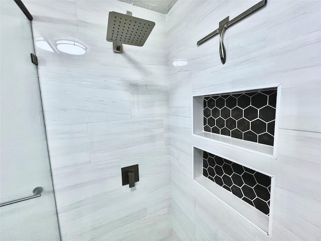 bathroom with a tile shower