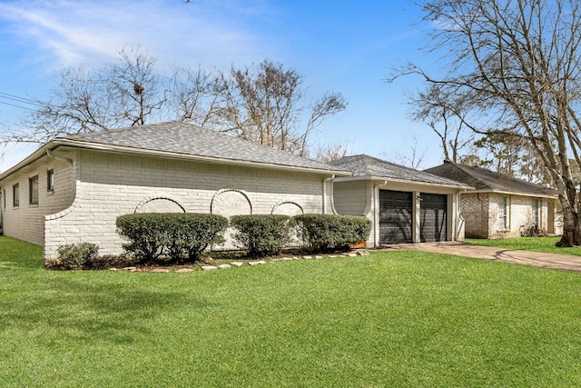 view of side of property with a yard and a garage