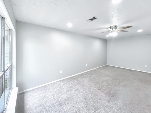 spare room with a textured ceiling and ceiling fan