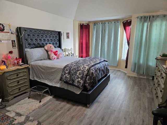 bedroom featuring vaulted ceiling and wood finished floors