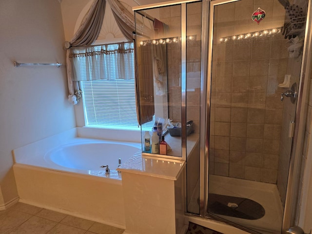 full bathroom with a stall shower, a garden tub, and tile patterned floors