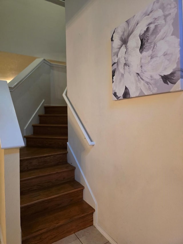 staircase with tile patterned floors