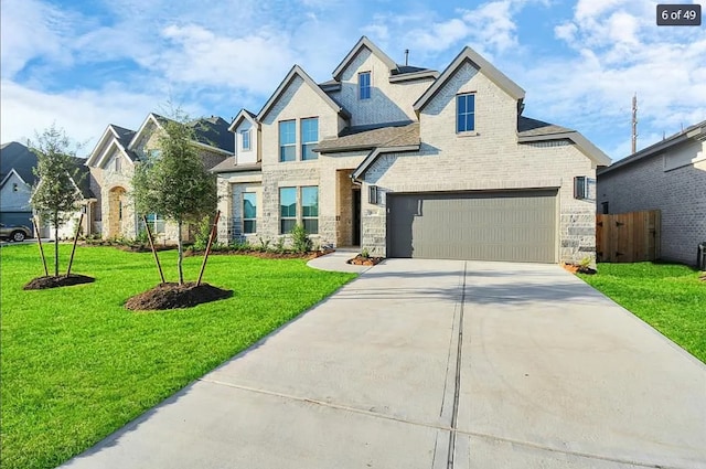 craftsman-style house featuring a garage and a front lawn