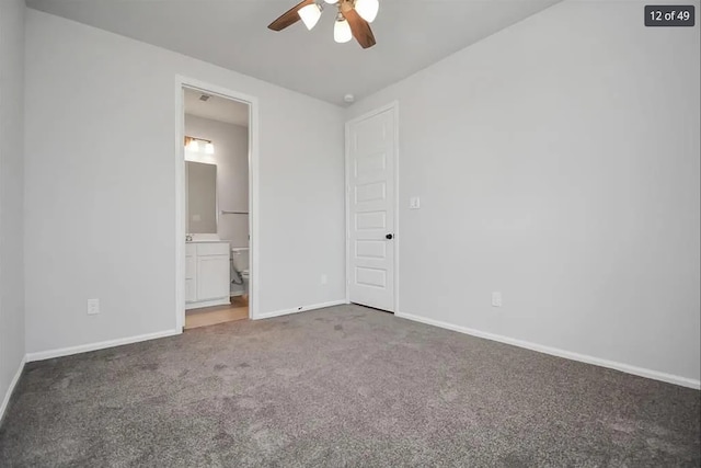 unfurnished bedroom with ceiling fan, ensuite bathroom, and carpet flooring