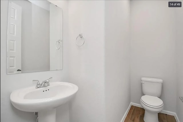 bathroom featuring sink, hardwood / wood-style floors, and toilet