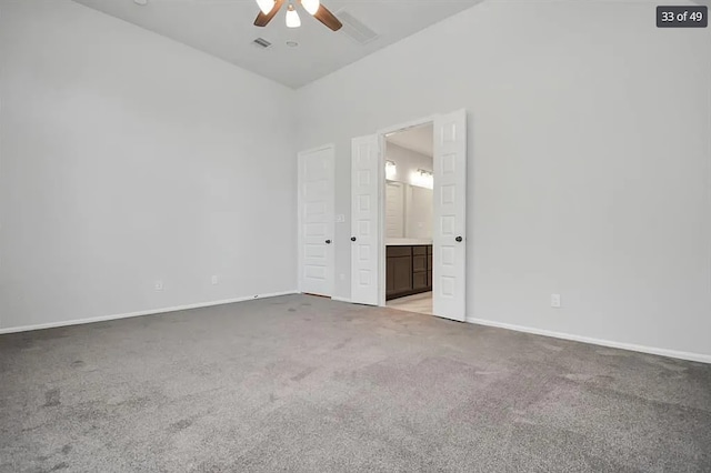 spare room featuring light colored carpet and ceiling fan