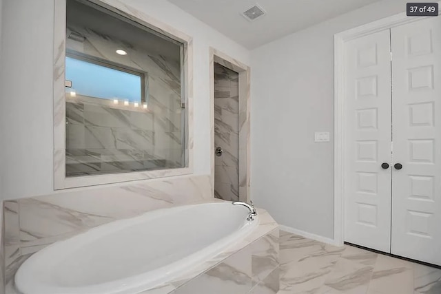 bathroom with shower with separate bathtub