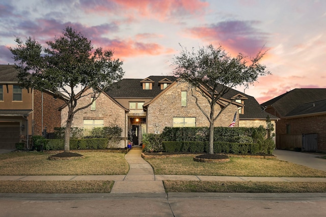 view of front facade with a garage and a lawn