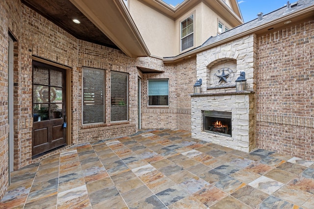 view of patio / terrace featuring an outdoor stone fireplace