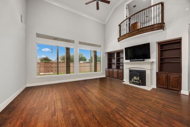 unfurnished living room featuring hardwood / wood-style floors, crown molding, high vaulted ceiling, and ceiling fan