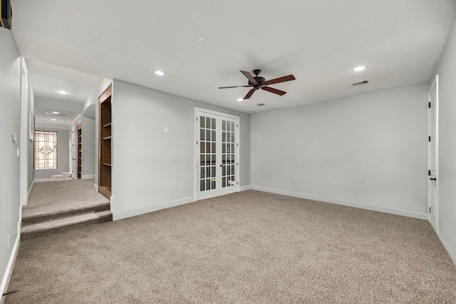 unfurnished room with french doors, ceiling fan, and carpet