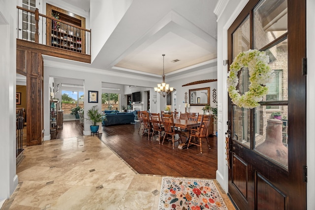 dining space with a notable chandelier, crown molding, and wood-type flooring