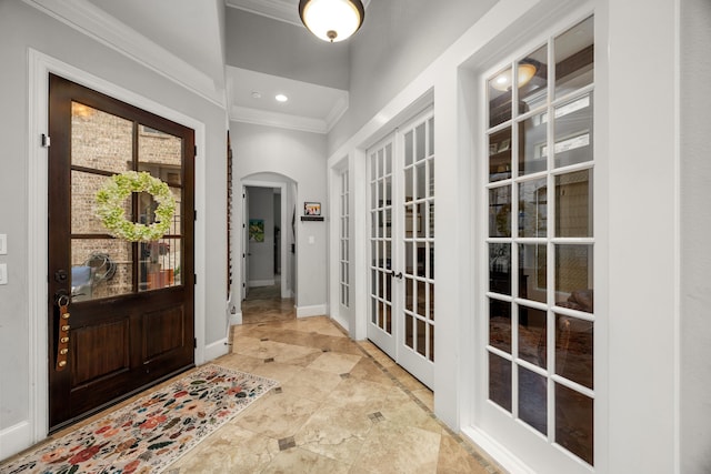 entrance foyer featuring ornamental molding and french doors