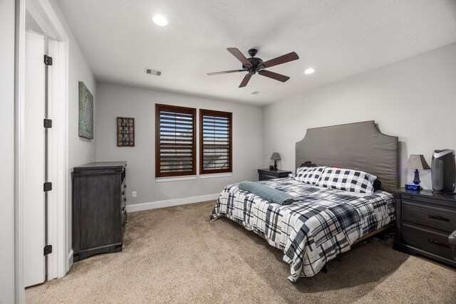 bedroom with light colored carpet and ceiling fan