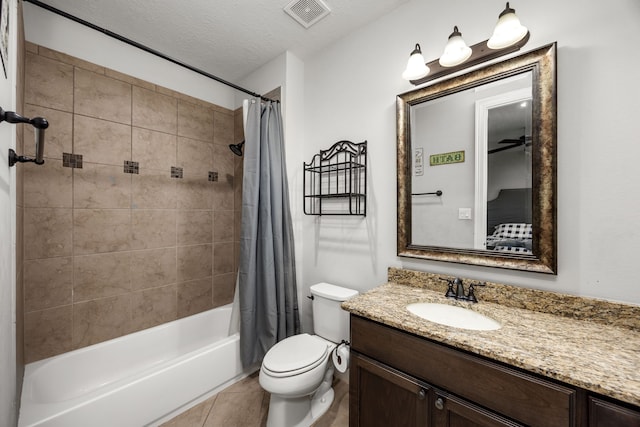 full bathroom with tile patterned floors, toilet, a textured ceiling, vanity, and shower / bathtub combination with curtain