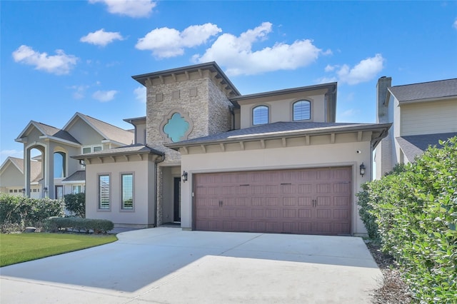 view of front of home with driveway, stone siding, a garage, and stucco siding