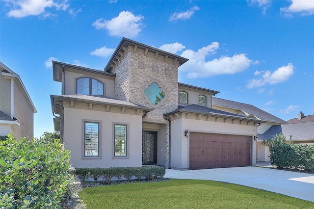 view of front of home featuring concrete driveway, stone siding, an attached garage, a front lawn, and stucco siding