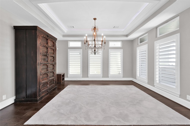 16434 Clear Water Cir, Montgomery, TX 77356 - bedroom featuring a chandelier, a raised ceiling, dark wood-style floors, and baseboards