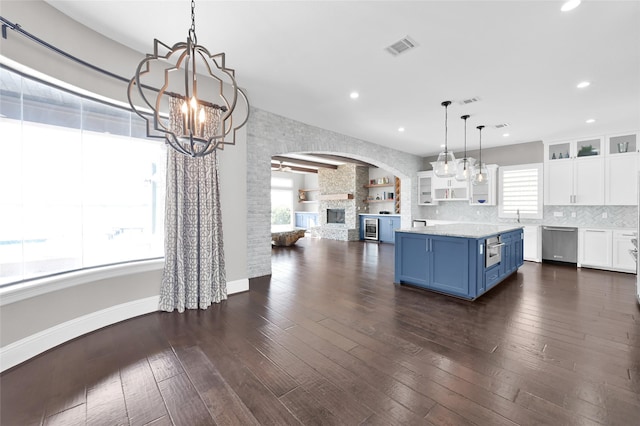 kitchen with dark wood-style floors, stainless steel dishwasher, white cabinets, and blue cabinets