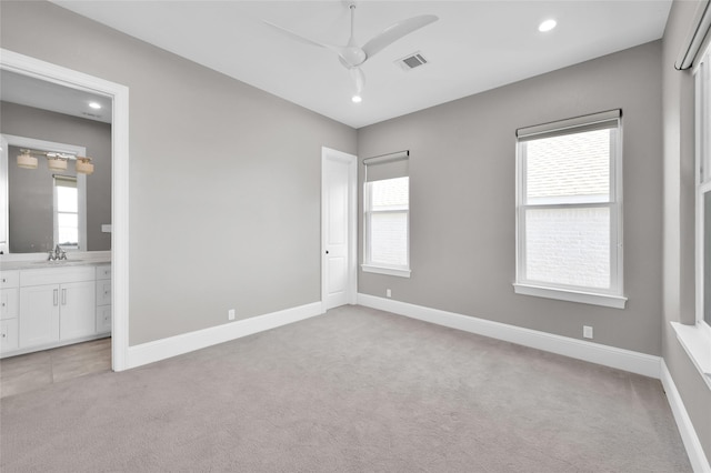 16434 Clear Water Cir, Montgomery, TX 77356 - unfurnished bedroom with light colored carpet, multiple windows, baseboards, and recessed lighting