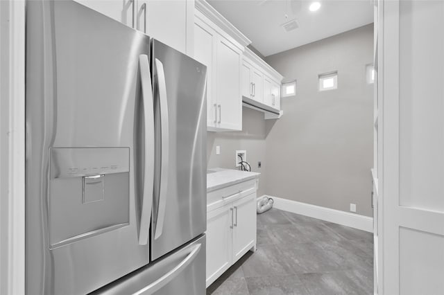 16434 Clear Water Cir, Montgomery, TX 77356 - kitchen featuring stainless steel refrigerator with ice dispenser, baseboards, white cabinets, and light stone counters