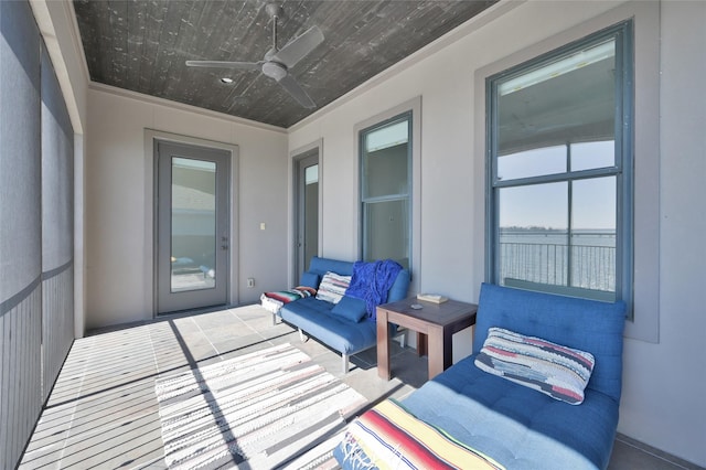 sunroom featuring ceiling fan