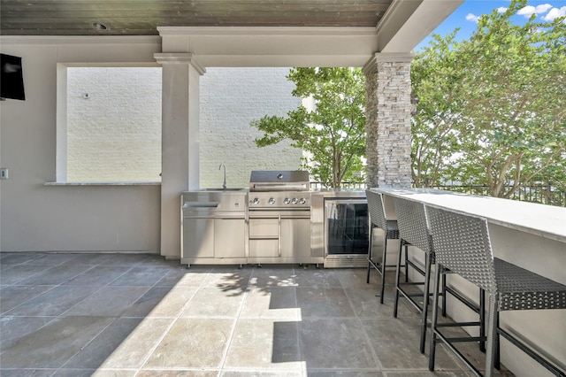 view of patio featuring a sink, a grill, exterior kitchen, and outdoor wet bar