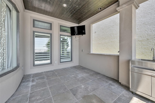 unfurnished sunroom with a sink and wood ceiling